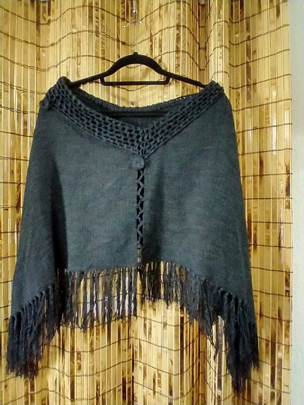 This is an Open-Knit / Crochet Trim Fringed Knit Poncho / Shrug in Dark Charcoal